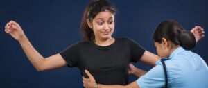 NEET re-exam security checks 2026 — student reacting to frisking at exam centre