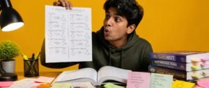 Student revising named reactions for NEET 2027 from a hand-drawn reaction chart