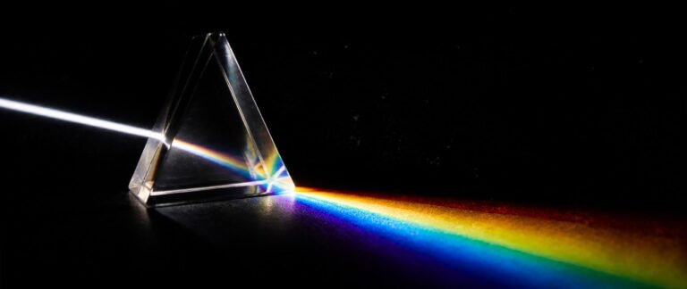 Prism splitting light into a spectrum illustrating ray optics for NEET 2027 refraction concepts